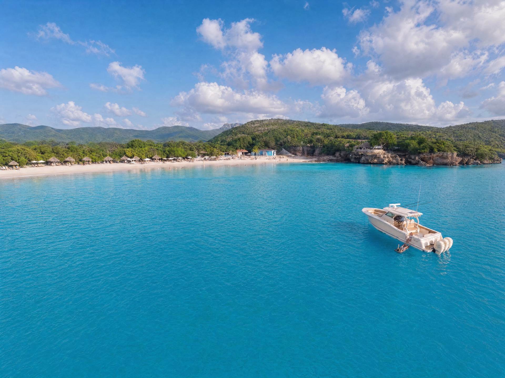 The Scout at anchor off Cas Abao, turquoise water